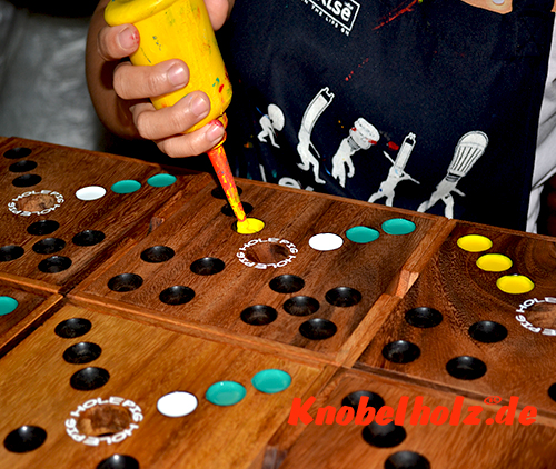 The colored design of the wooden game Pig Hole the pig game is also handmade